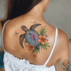 a woman with a turtle tattoo on her upper back shoulder and chest, holding an orange flower