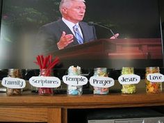 a television screen with some jars and candy in front of it that says, i love jesus