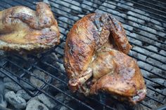 two pieces of meat cooking on a grill