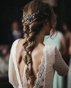 the back of a woman's head wearing a wedding hair piece