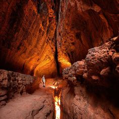 a person standing in the middle of a cave