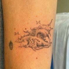 a woman with a tattoo on her arm has a shark and fish design on it