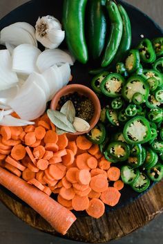 vegetables are arranged on a cutting board with spices and seasonings