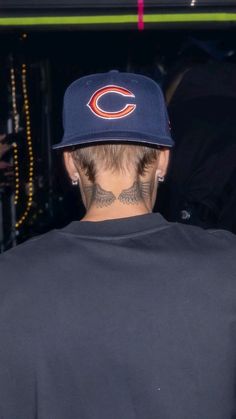 the back of a man's head wearing a chicago bears baseball cap with tattoos