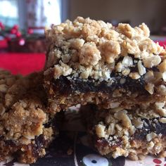 three pieces of granola bars stacked on top of each other in a blue and white plate