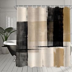 a bathroom with a bathtub, toilet and shower curtain in black and beige colors