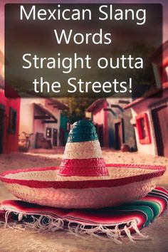 a mexican hat sitting on top of a red and white blanket in the middle of a street