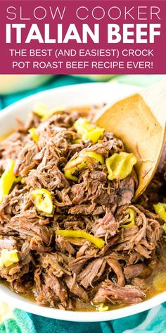 slow cooker italian beef in a white bowl with a wooden spoon on the side