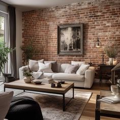 a living room filled with furniture and a painting hanging on the brick wall behind it