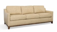 a beige couch sitting on top of a white floor