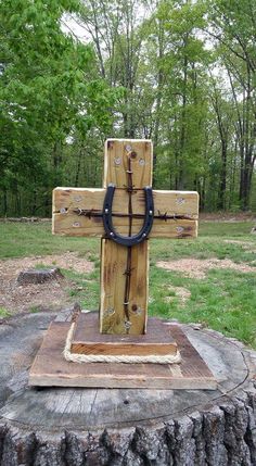 a wooden cross sitting on top of a tree stump