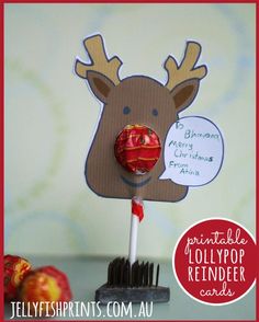 a reindeer lollipop holder with an apple on it's side and some candy in the middle