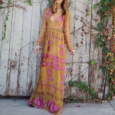 A customer favorite is perfect for fall. This maxi dress has a soft chiffon mustard & rose printed base, a crochet trimmed deep v-neck, long sleeves, and a full flowy skirt. Constructed with inner briefs for a breezy boho vibe. Side pockets and a zipper back closure. Lighter color shown for fit. Custom made to order. Please allow 2-3 weeks for production. Color: Mustard & rose 100% rayon Imported Hand wash cold split Small/Medium Medium/Large Bust 35 37 Waist 33 35 Hips 38 39 Length 54 5 Bohemian Long Sleeve Dress, Boho Dress Fall, Bohemian Maxi Dress, Love And Lemons, Flowy Skirt, Crochet Trim, Boho Vibe, For Love And Lemons, Rose Print