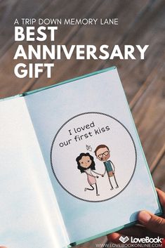 a person holding an open book with the words best anniversary gift written on it in front of them