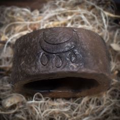 a piece of metal that has been carved into some kind of thing with water drops on it