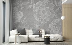 a living room with white furniture and floral wallpaper on the walls, along with a glass coffee table