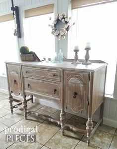 an old dresser is painted white and has flowers on it, along with other decorations