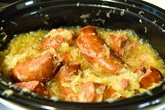 a crock pot filled with sausage and rice