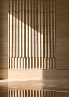 an empty room with wooden slats on the wall