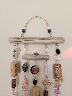 a wall hanging with various beads and wooden sticks on it's sides, along with other beaded items