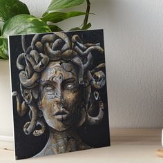 a painting of a woman's head with snakes on her hair art board print