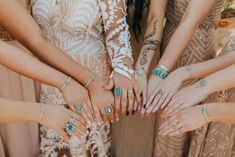 a group of women standing next to each other with their hands on top of each other