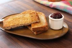 two pieces of bread on a plate with jam