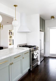 a kitchen with an oven, stove and cabinets in it's center island area