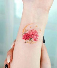 a woman's wrist with flowers on it