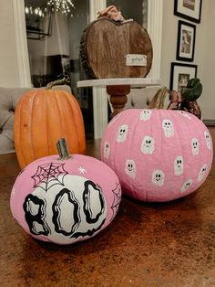 two pink pumpkins decorated with black and white designs