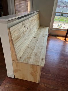 a kitchen counter made out of plywood and white paint on top of a hard wood floor