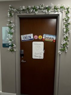 a door decorated with stickers and flowers on the front entrance to an office building