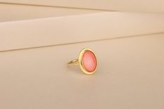 Our Coral Gemstone Women Ring in Gold and Silver is the perfect gift for your loved one. Coral has been used as jewelry for thousands of years, and for good reason: it's beautiful. It's also believed to have healing properties, which makes it the perfect gift for your mom, girlfriend, or wife. This ring has a simple and elegant design that will make you feel like royalty when you wear it. The oval stone is set in a beautiful gold band with a silver accent on top. The minimalist design allows this ring to go with any outfit while still standing out as something special and unique. Details of the product Material: 10K and 14K Solid Gold, Silver Gemstone: Coral Gemstone Gemstone Size: 12x16 mm Unique Gift For people whom you love; Mom, Girlfriend, Wife, Fiance, Best Friend; Dainty Gift Idea; Minimalist Oval Cabochon Wedding Ring, Pink Oval Stackable Rings, Delicate Oval Rings For Gift, Delicate Oval Rings For Gifts, Oval Stackable Rings For Gift, Minimalist Oval Rings For Gifts, Oval Minimalist Rings For Gifts, Minimalist Oval Rings As Gifts, Modern Oval Stackable Rings As Gift