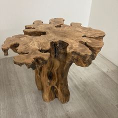 a wooden table made out of logs on the floor