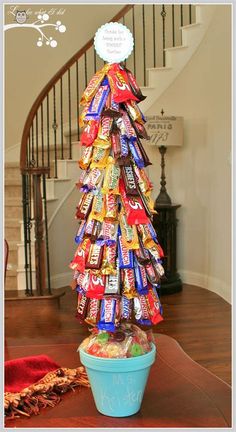 a christmas tree made out of candy bars is shown next to an image of a woman