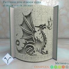 an open book with a drawing of a dragon on it