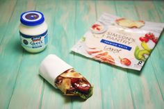 a wrapper sitting on top of a table next to a jar of mayonnaise