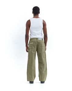 Straight loose fit pants. Stone-washed green canvas. 100% heavy cotton fabric. Zipper closure with Cold engraved on button. Triple stitch. Double Knee Reinforcement. Tool pockets and hammer loop. Male (182cm, 5'11"): M - National Shipping 24-48H (Spain / Portugal) - CORREOS EXPRESS - European Shipping 48-72H - FEDEX - International Shipping 5-7 working days - FEDEX Khaki Cotton Utility Jeans, Military Wide Leg Cotton Cargo Jeans, Green Jeans With Patch Pockets For Streetwear, Green Baggy Cargo Jeans With Hip Pockets, Green Baggy Cotton Jeans, Green Cotton Cargo Jeans With Patch Pockets, Green Streetwear Bottoms With Patch Pockets, Green Cotton Parachute Pants For Streetwear, Green Bottoms With Patch Pockets For Streetwear