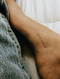 a person's foot with the word love written on it in cursive writing