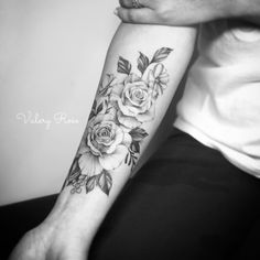 a woman's arm with flowers on it and the words, valley rose written in black ink