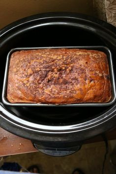 a loaf of bread sitting in an electric crockpot on top of a table