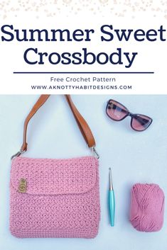 a pink crocheted purse next to a ball of yarn and a pair of sunglasses