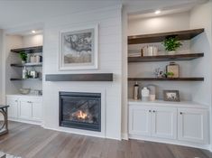 a living room filled with furniture and a fire place