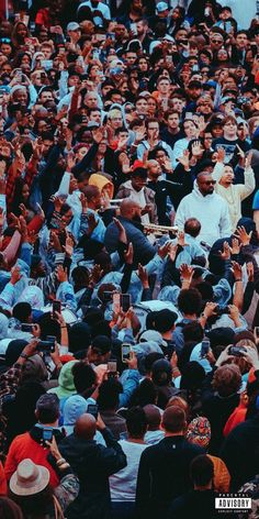 a large group of people standing around each other