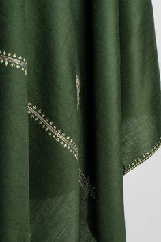 Immerse yourself in the elegance of this deep forest green merino wool scarf, beautifully hand-embroidered with intricate Sozni floral motifs. The subtle blossom patterns are carefully placed to enhance the simplicity of the design while showcasing the artistry of Kashmiri craftsmanship. This lightweight and soft scarf offers a timeless charm, perfect for both casual and formal wear. The delicate embroidery along the borders adds a refined touch, making it a graceful addition to any wardrobe, id Sozni Embroidery, Embroidered Rug, Deep Forest Green, Scarf Jacket, Embroidered Handbag, Merino Wool Scarf, Delicate Embroidery, Soft Scarf, Silk Carpet