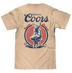 The Beer Shirt They'll Steer At!We really don't want to start any beef over that bad pun, but we think fans of Coors and the rough and tough rodeo life won't mind it a bit! We've paid tribute to the Coors brand, and the brave cowboys that saddle up and compete with this double sided beer t-shirt, featuring the "Original Coors" text logo on the front left chest, and a full-sized version of logo on the back along with a bull riding graphic and "Rodeo Legend" text. As an added nod to Coors Rodeo's Coors Rodeo Shirt, Retro Summer T-shirt For Rodeo, Country Boy Outfits, Vintage Beer Shirts, Retro Rodeo Crew Neck T-shirt, Beer Merchandise, Rodeo Graphic Crew Neck T-shirt, Country Hats, Beer Logo