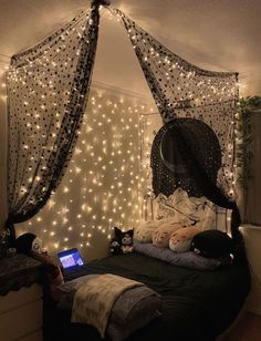 a bedroom with lights on the walls and a bed in front of a laptop computer