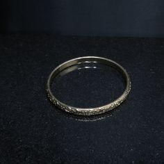 *Description: This is a great Whiting & Davis embossed gold tone floral bangle bracelet from the late 1960s to 1970s. The bracelet is in great condition and is signed on the inside of the bangle. This would be a great vintage bangle bracelet for your collection of Whiting & Davis and would also make a great gift. It would be the perfect bracelet to layer with other bangles. It is an over the hand bracelet, no clasp. *Approximate Measurements: Length - 7 1/2 Inches, Width - 1/4 Inch *Cond Gold Brass Bangle Bracelet For Formal Occasions, Antique Gold Bangle For Formal Occasions, Antique Gold Bangle Jewelry For Formal Occasions, Antique Gold Brass Bracelets For Formal Occasions, Engraved Gold Metal Bracelet For Formal Occasions, Formal Engraved Gold Metal Bracelet, Formal Antique Gold Brass Bracelets, Formal Antique Gold Brass Bracelet, Classic Gold Etched Bangle