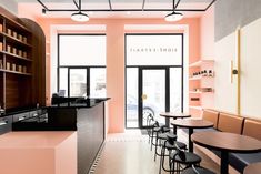 the inside of a restaurant with tables, chairs and counter tops in front of large windows