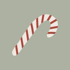 a candy cane with red and white stripes on the top, against a gray background